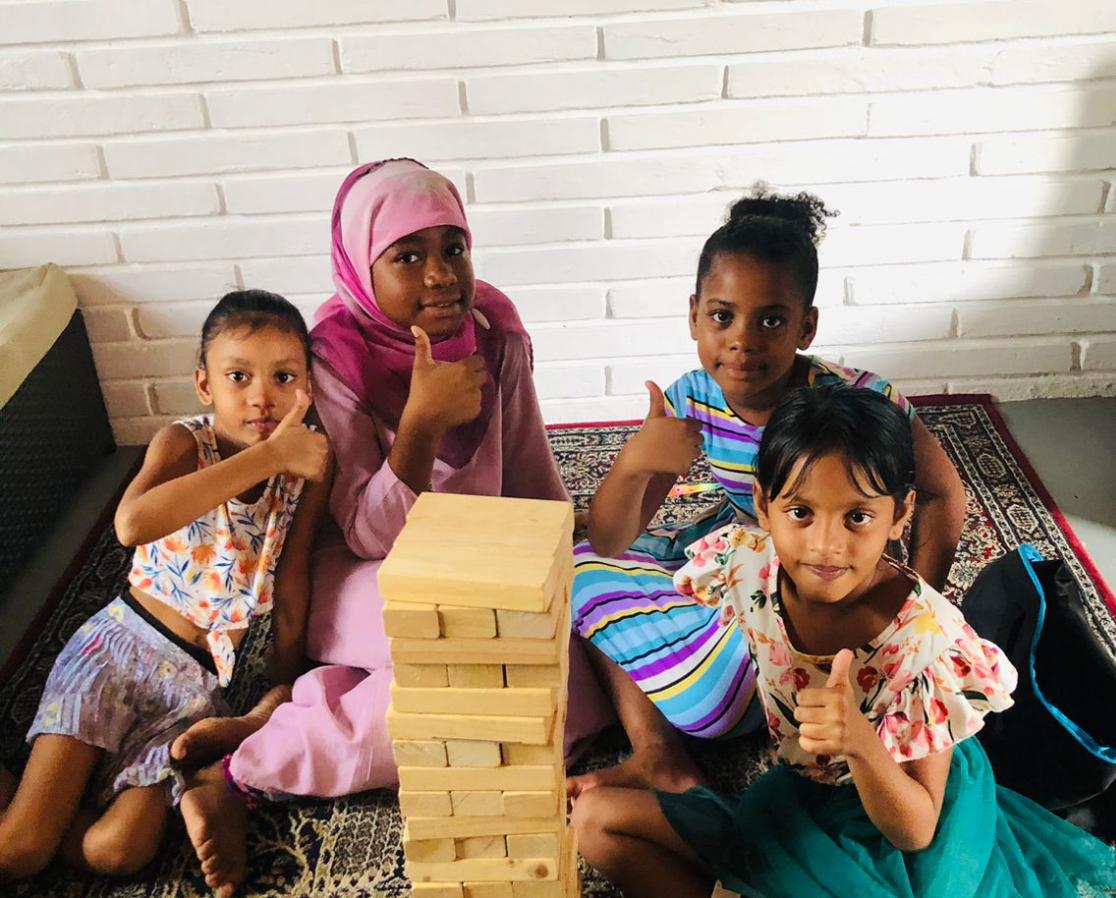 The kids enjoy an indoor game during the summer camp