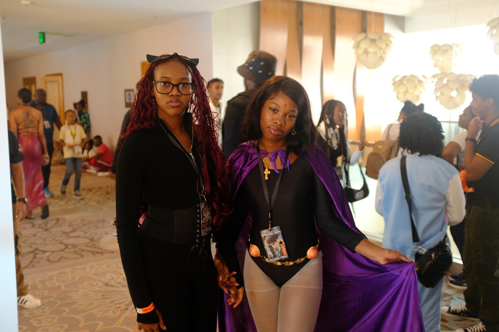 Two friends dressed as Catwoman and Raven at the event