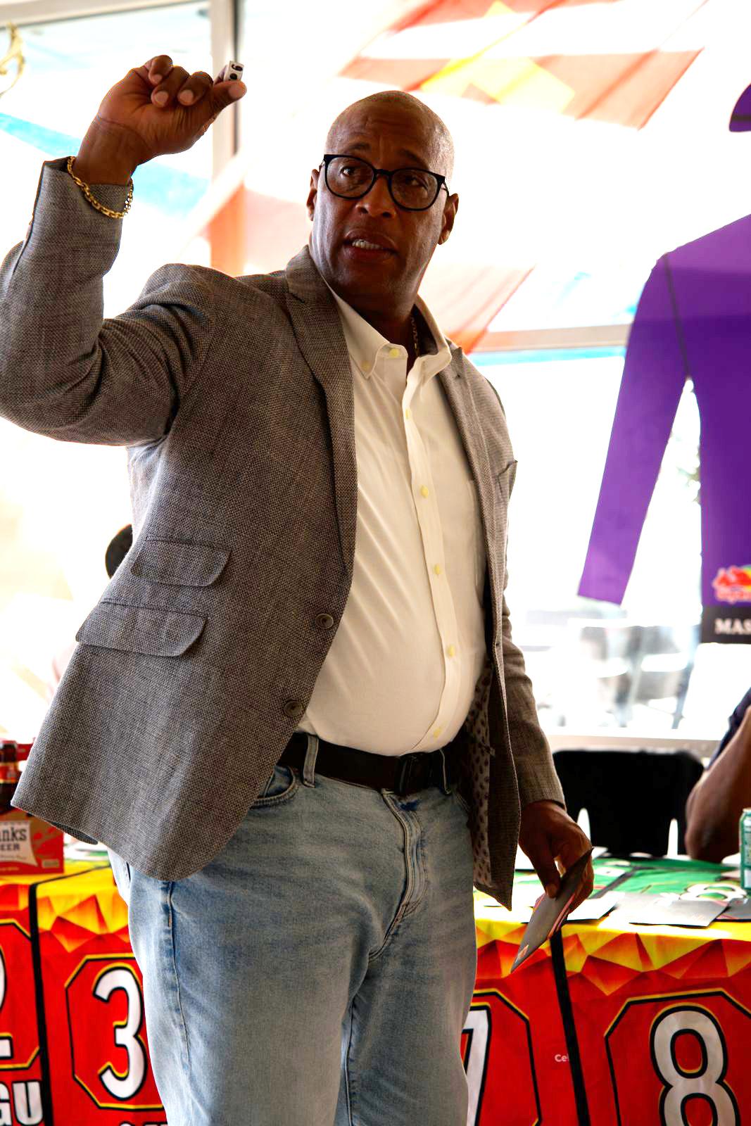 Mortimer George of Banks DIH displays a number during the Guyana Cup Press Conference draw