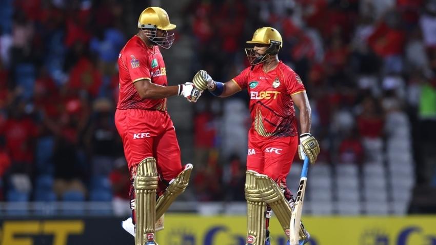 Nicholas Pooran (right) and Kieron Pollard celebrate during the contest. (CPL via Getty Images)