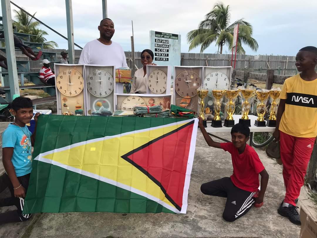 RHTYSC secretary Hilbert Foster hands over items to Rose Hall Town Clerk Natasha Griffith
