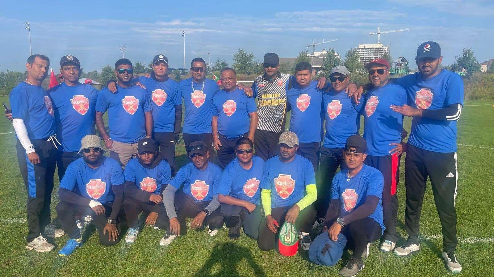 The victorious Hamilton Steelers team strikes a pose after the game.