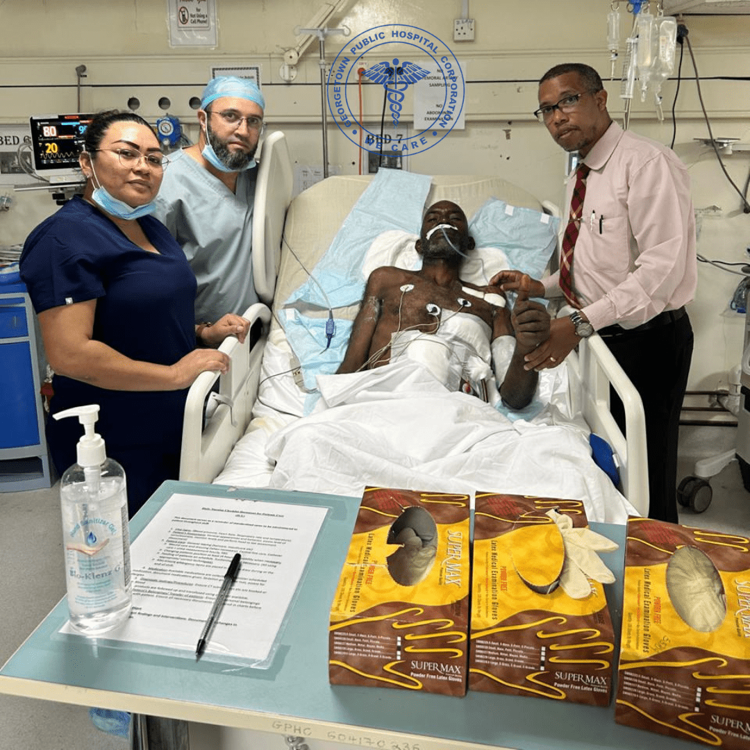 The patient surrounded by doctors following the successful surgery
