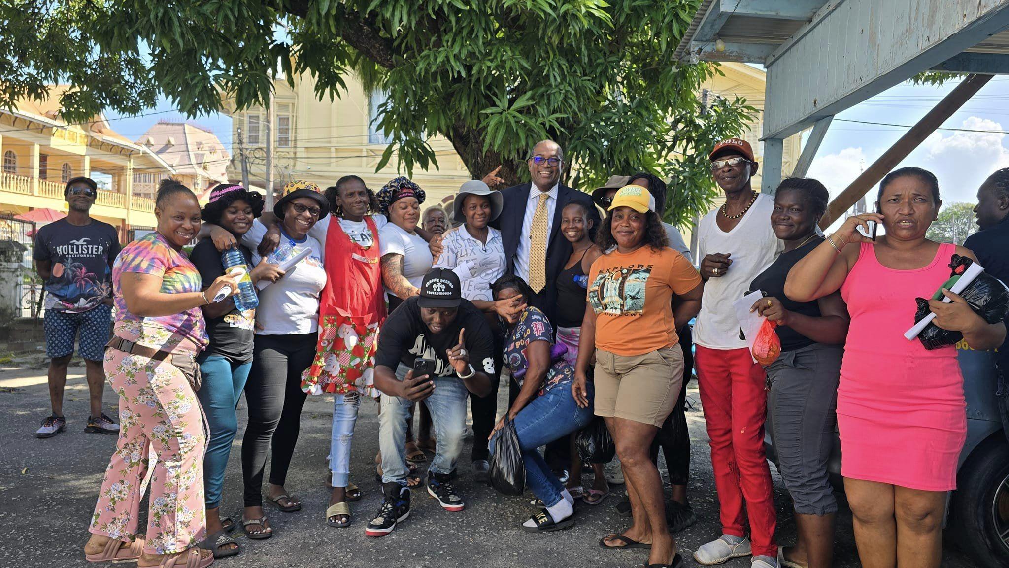 Some of the vendors and attorney Nigel Hughes following a meeting at City Hall on Thursday.