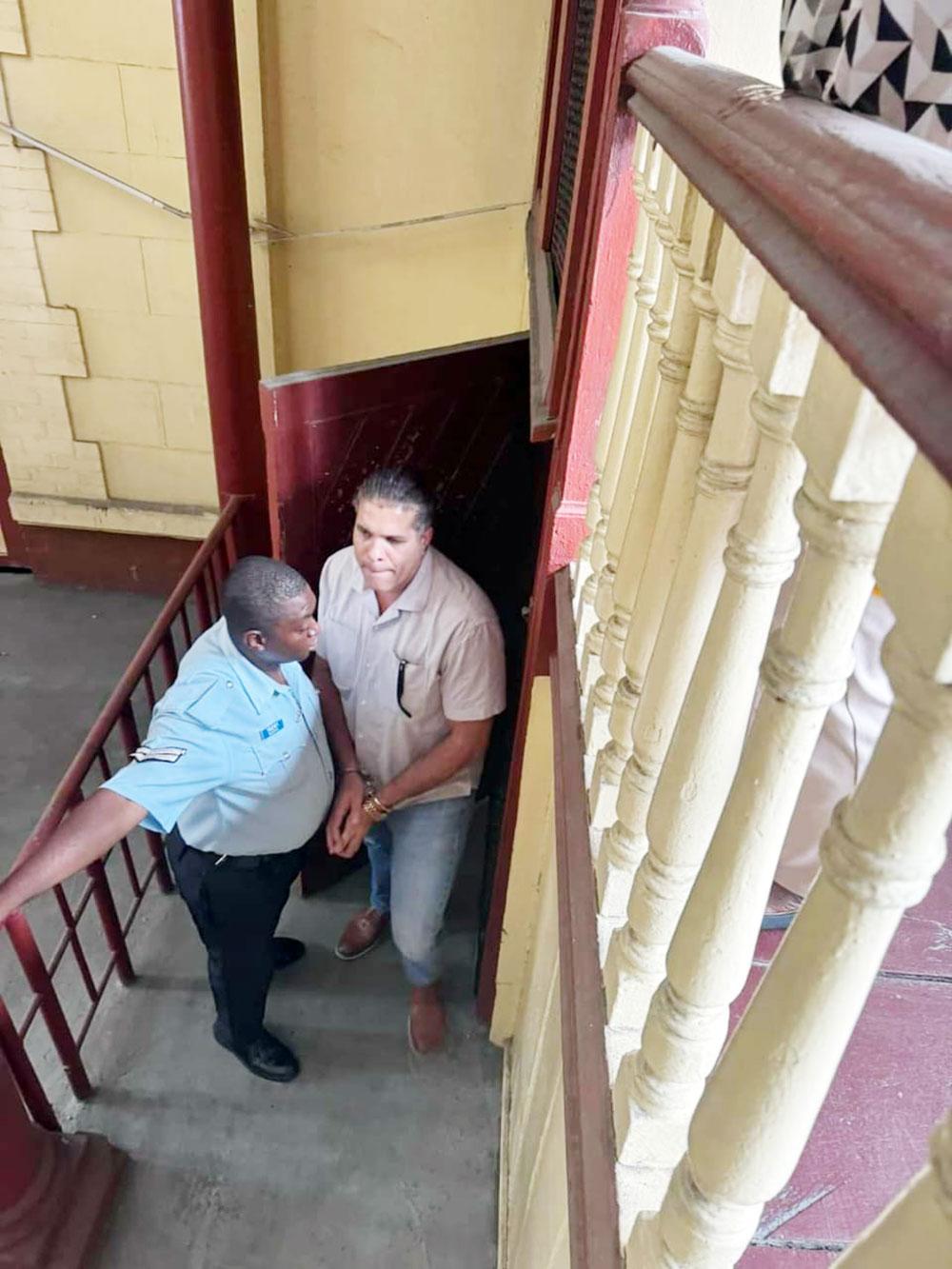 Mikhail Rodrigues aka Critic leaving the court room shackled