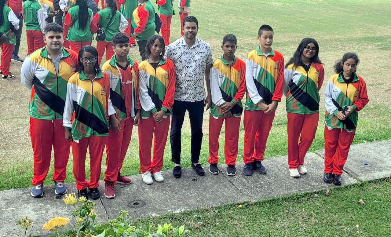 Minister of Sports, Charles Ramson shares photo with members of the Guyana Chess team on Sunday.