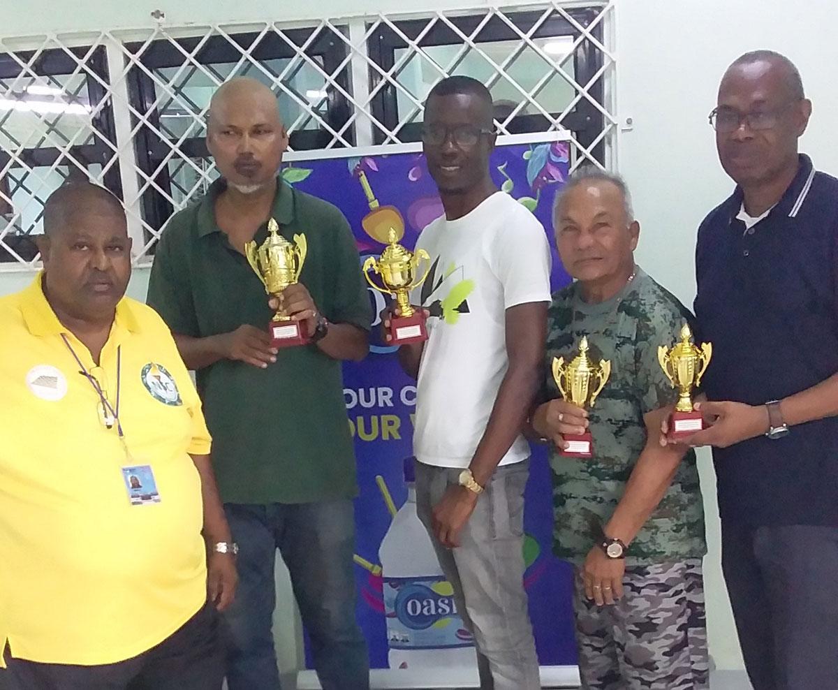 President of Draughts Association Mr. Jiaram (left) poses with the four winners.