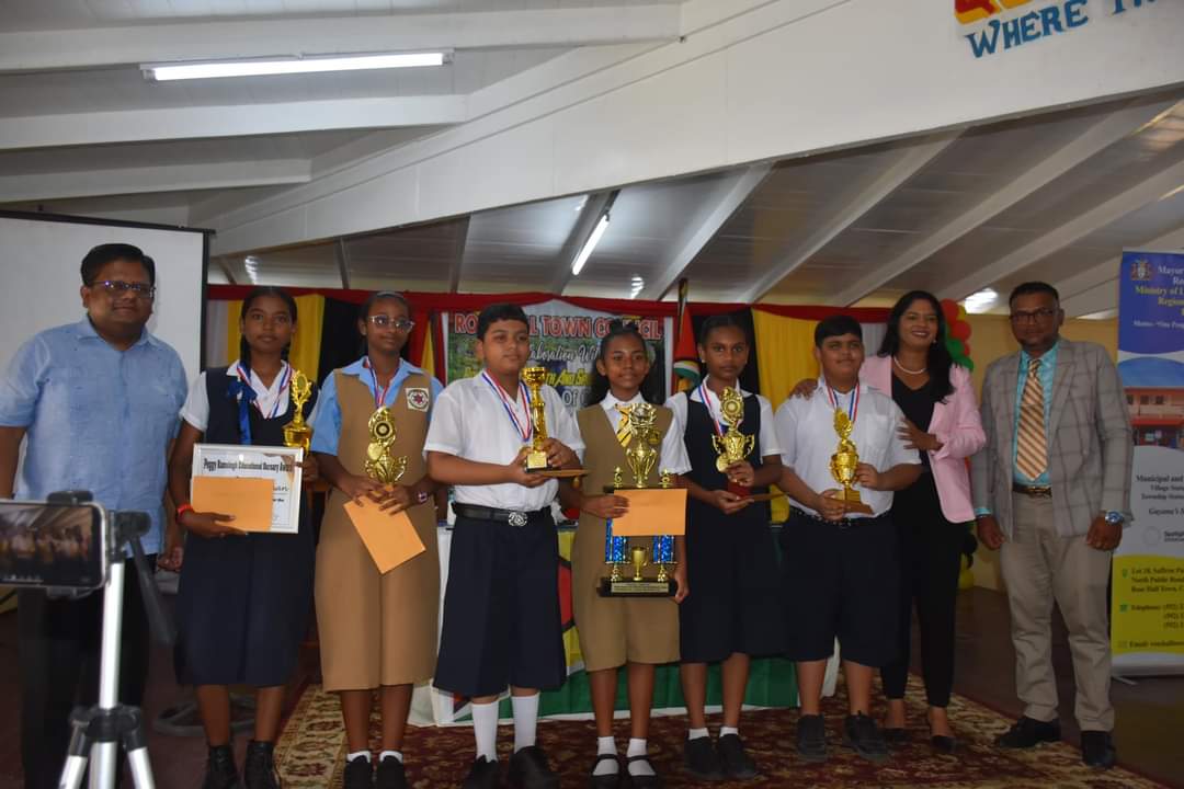 The grade six students pose with Ministers Ashni Singh and Sonia Parag.