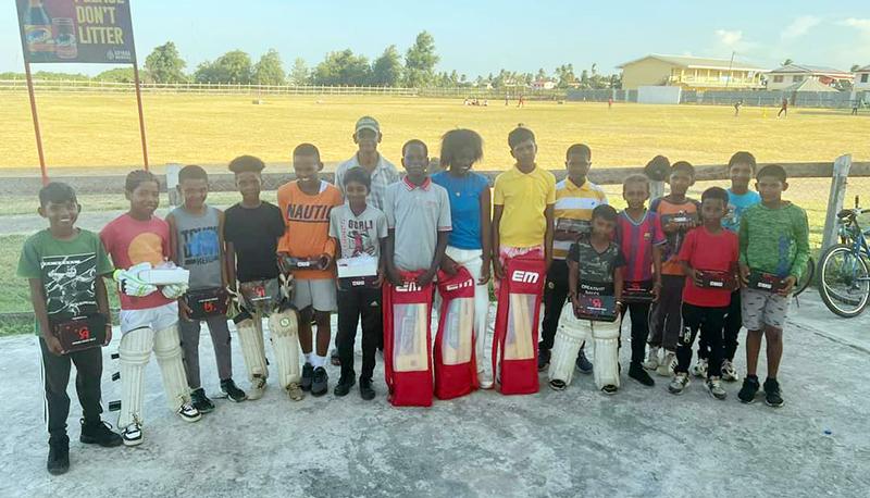 Youth cricketers pose with some of the newly acquired equipment.