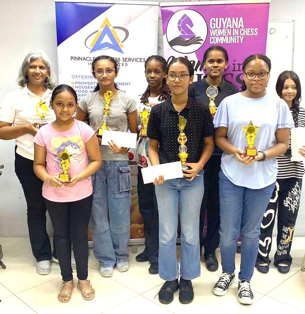 Queenside Rapid Chess Tournament winners share photo-op with individual trophies.