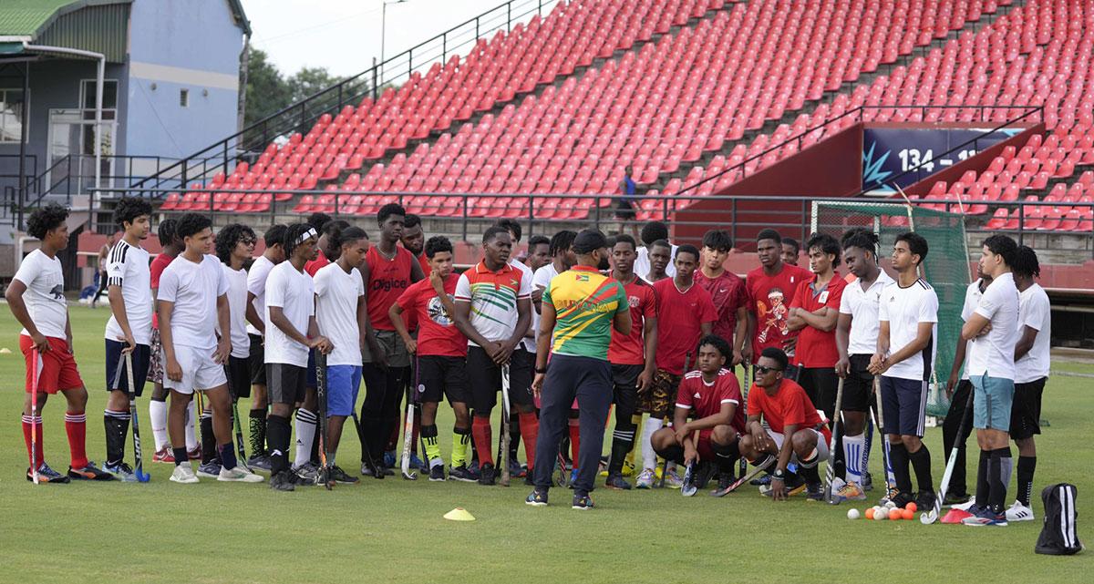 Hockey players being instructed during a training session.